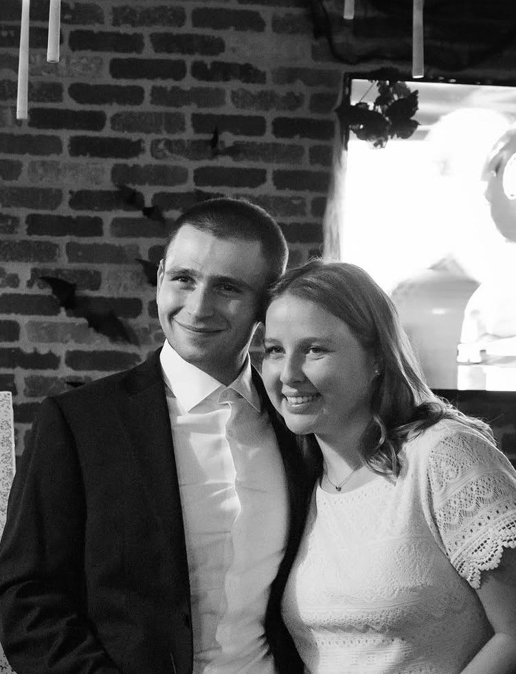 Katie and Joseph smiling together at their engagement celebration
